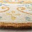 Safavieh Novelty 5' Round Hand Tufted Wool Rug in Gold and Ivory