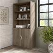 Hybrid Tall 5 Shelf Bookcase with Doors in Modern Hickory - Engineered Wood