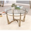 Bowery Hill Round Glass Top Coffee Table in Champagne