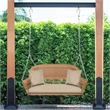 Pemberly Row Resin Wicker Hanging Porch Swing with Cushion in Honey/Tan