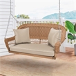 Pemberly Row Resin Wicker Hanging Porch Swing with Cushion in Honey/Tan