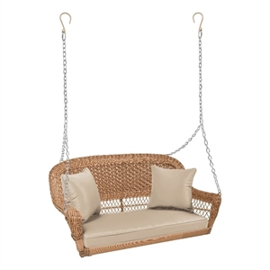 Pemberly Row Resin Wicker Hanging Porch Swing with Cushion in Honey/Tan