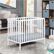 Pemberly Row Contemporary Wood Mini Crib with Mattress Pad in White
