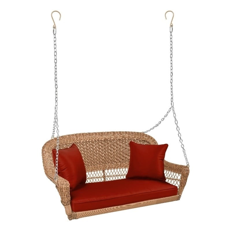 Pemberly Row Honey Resin Wicker Hanging Porch Swing with Cushion in Red