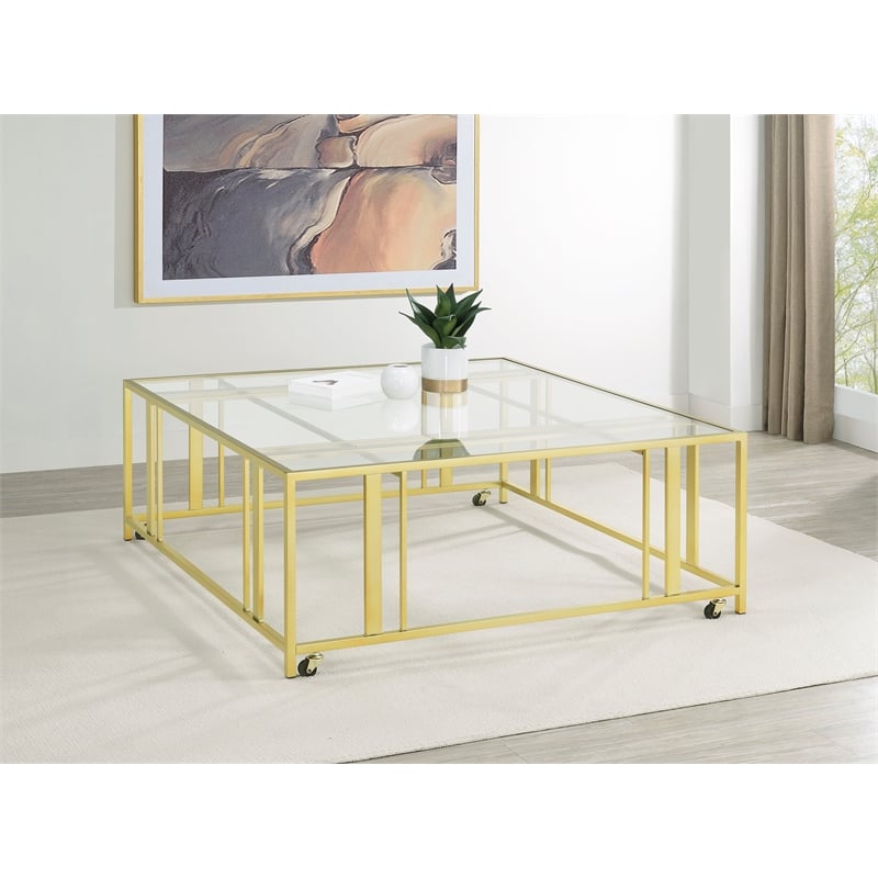 Pemberly Row Square Glass Top Coffee Table with Casters in Gold