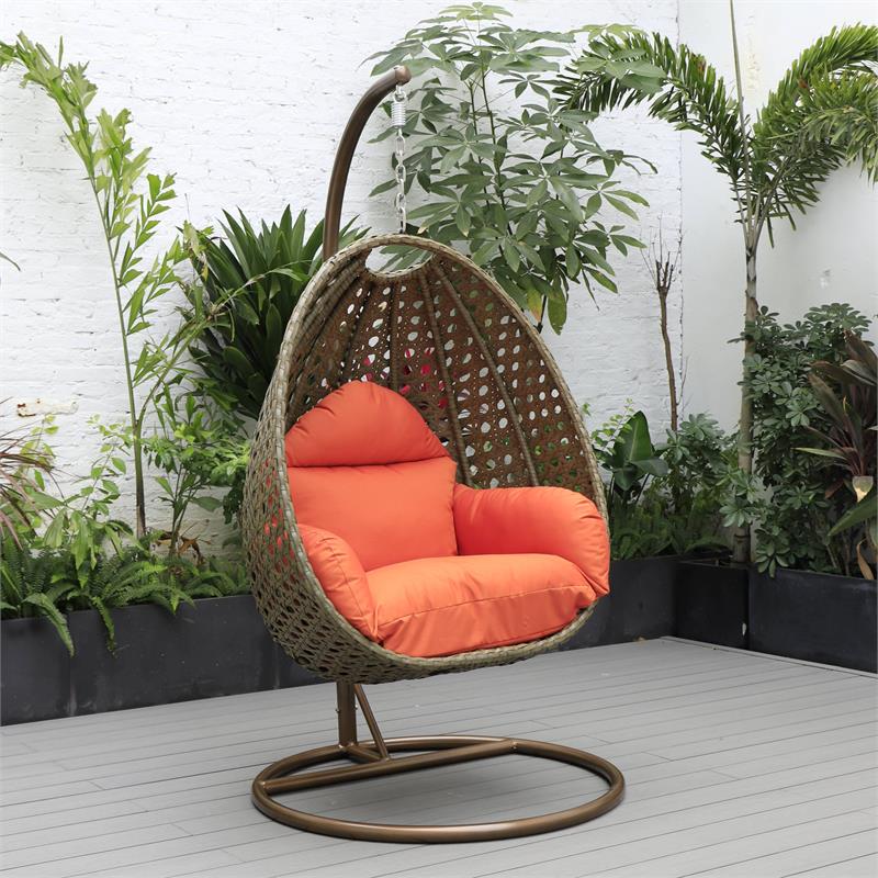 LeisureMod Beige Wicker Patio Egg Swing Chair with Stand in Orange