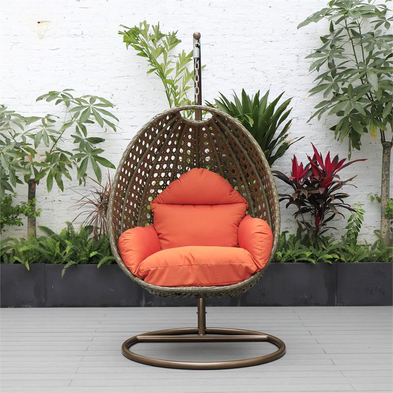 LeisureMod Beige Wicker Patio Egg Swing Chair with Stand in Orange