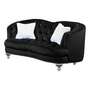 love seat with black velvet fabric upholstery and white fur pillows