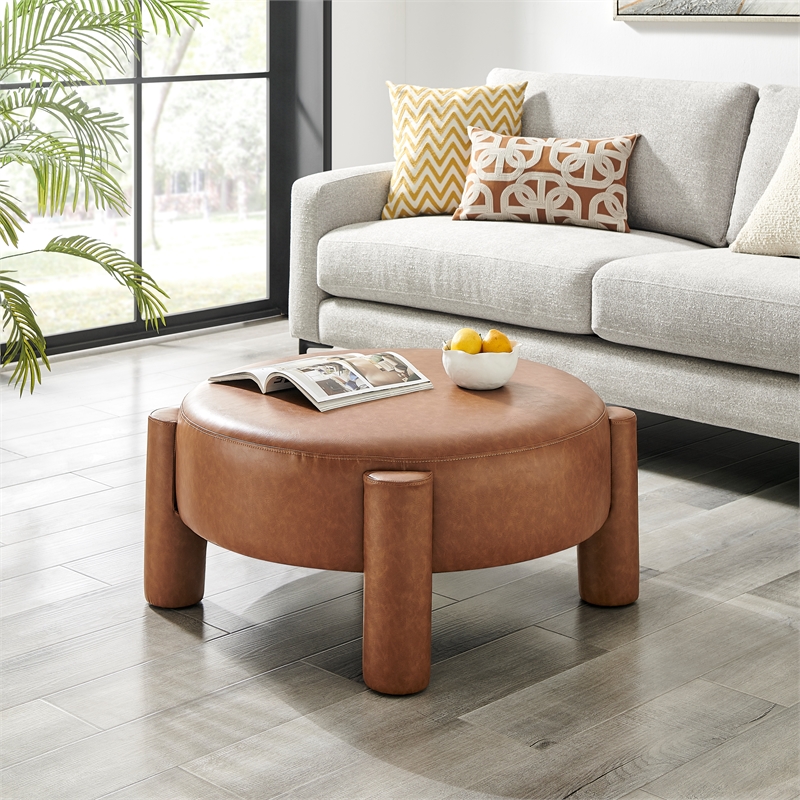 New Pacific Direct Elora Faux Leather Round Ottoman in Vintage Cider