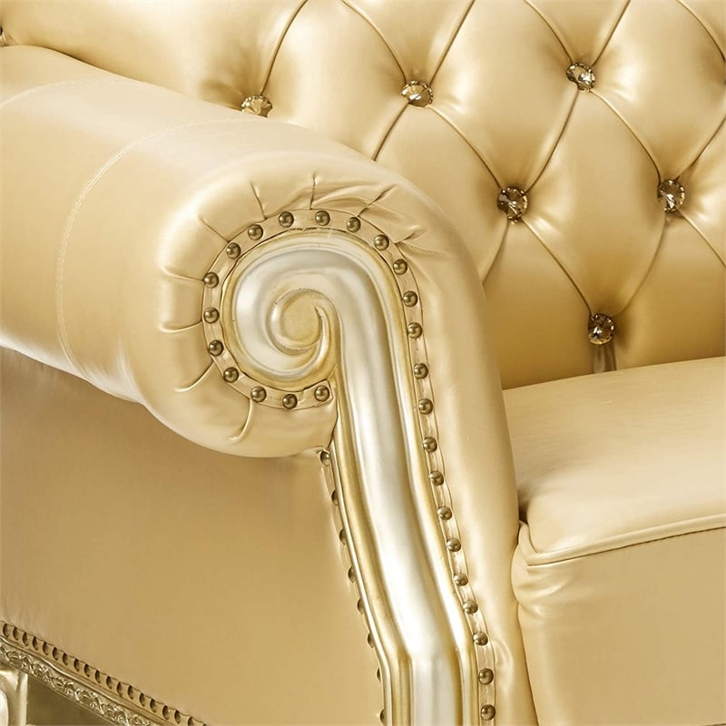 Benjara Traditional Button Tufted Leatherette Loveseat with Carved Details- Gold
