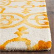 Safavieh Dip Dye 7' Round Hand Tufted Wool Rug in Ivory and Gold