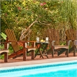 Pemberly Row Traditional Cedar Wood Patio Deck Adirondack Chair in Brown