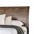 Pemberly Row Queen Bed with Curved Panel Headboard and Rivet Accents in Brown