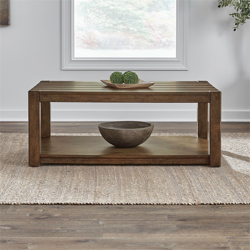 Pemberly Row Rectangular Cocktail Table with Casters and Open Shelf in Brown
