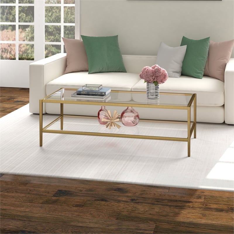 Henn&Hart 54 in. Antique Brass Finish Coffee Table with Clear Glass Shelf