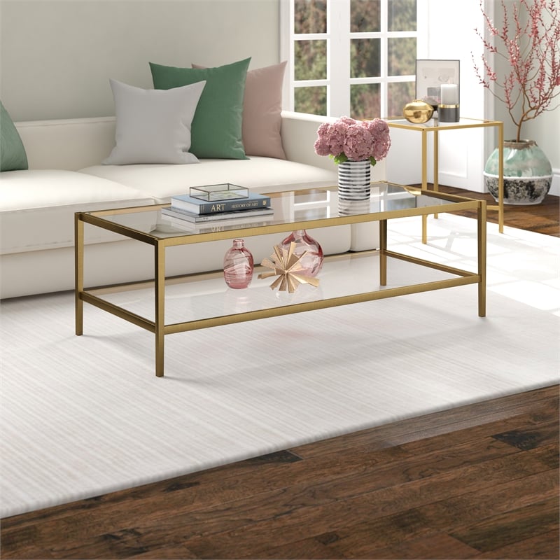 Henn&Hart 54 in. Antique Brass Finish Coffee Table with Clear Glass Shelf