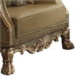 Benjara Traditional Button Tufted Leatherette Chair with Carved Details- Gold