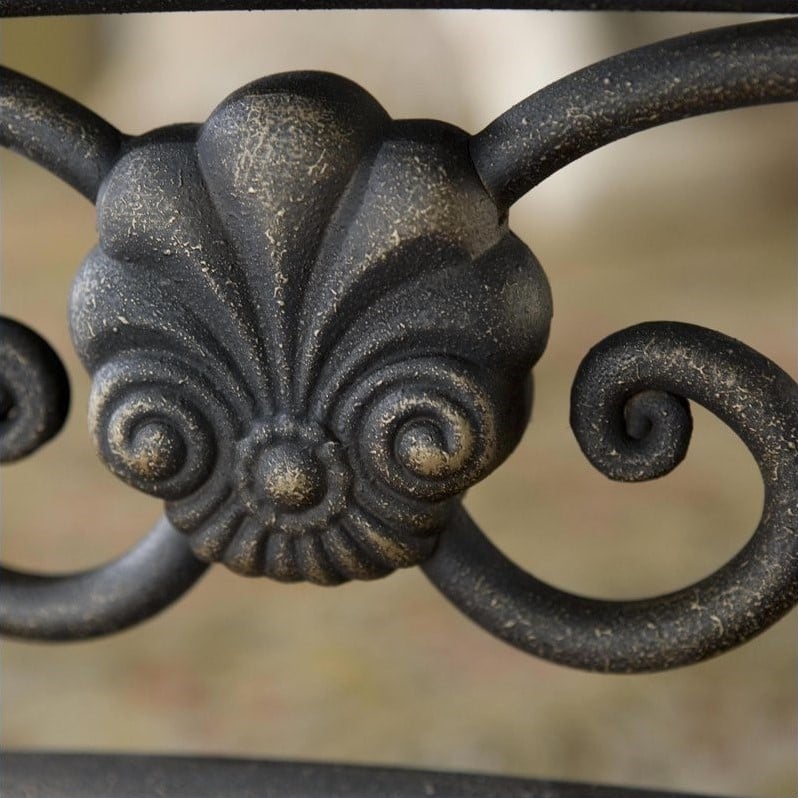   bed combines both delicate scrollwork with imposing posts and finials